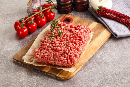 Raw minced beef uncooked meat over boardの写真素材