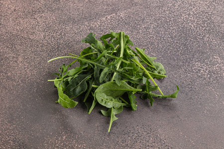 Green organic Arugula heap over background