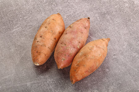 Raw ripe sweet potato heap for cookingの写真素材