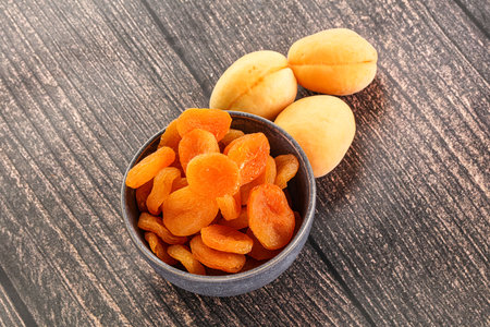 Dried sweet apricot heap in the bowlの写真素材