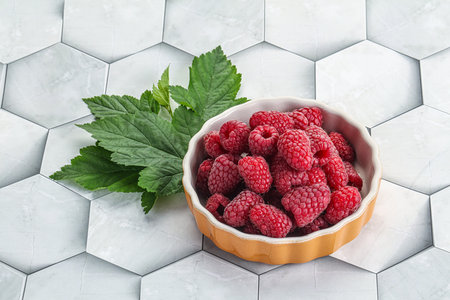 Rope sweet juicy raspberry heap in the bowl