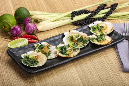 Grilled scallops with green onion and sauceの写真素材