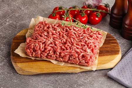 Raw minced beef uncooked meat over boardの写真素材