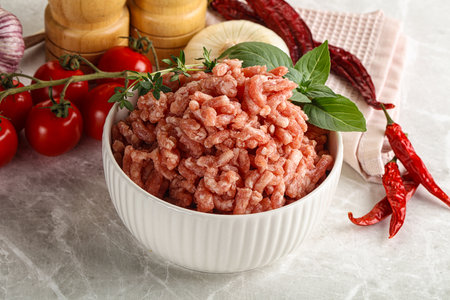 Raw minced pork uncooked meat in the bowlの写真素材