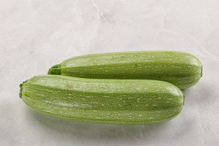 Raw green ripe zucchini vegetable for cookingの写真素材