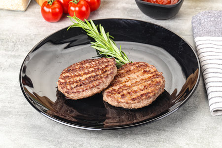 Grilled two beef burger cutlet served rosemary