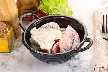 Salad with sliced tomato and stracciatella cheeseの写真素材