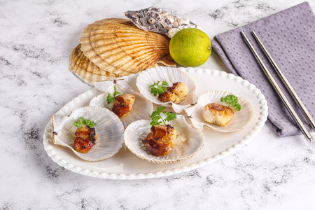 Grilled scallops shell with butter and parsleyの写真素材
