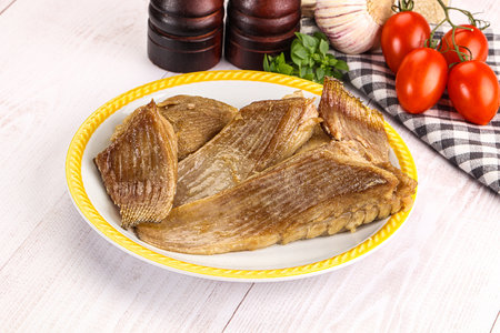 Baked stingray witngs with oil and spices