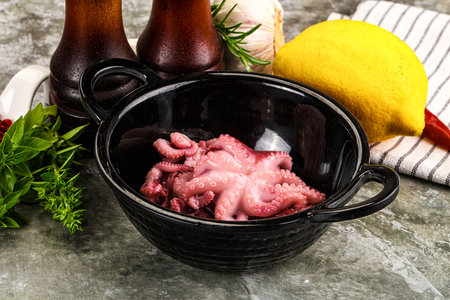 Marinated baby octopus snack appetizer served lemonの写真素材