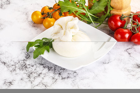Creamy Italian traditional Burrata cheese served tomato and rucolaの写真素材