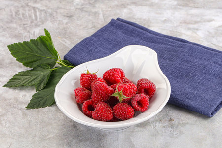 Ripe sweet and juicy organic raspberry in the bowl