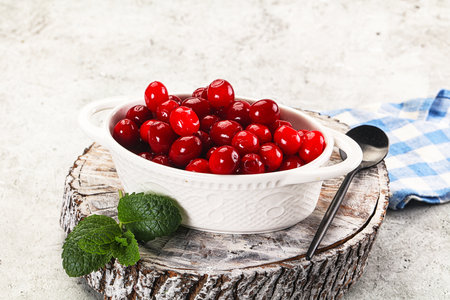 Red sweet ripe juicy cranberry in the bowlの写真素材