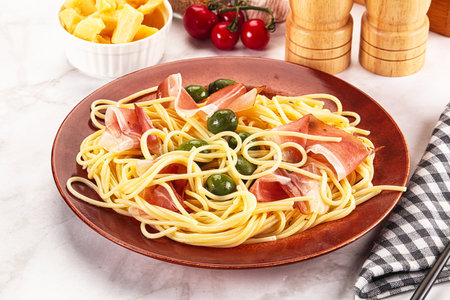 Delicious Pasta spaghetti with olives and jamonの写真素材