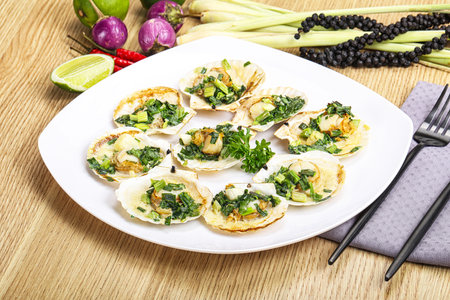 Grilled scallops with green onion and sauceの写真素材