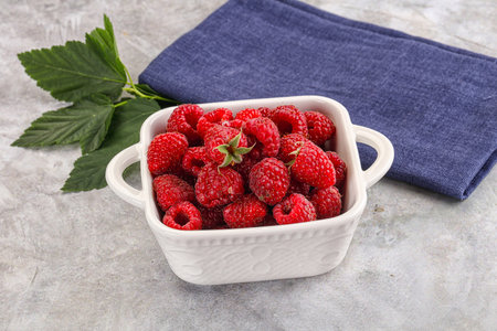 Ripe sweet and juicy organic raspberry in the bowl