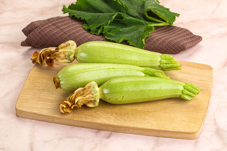 Green young small baby zucchini for cookingの写真素材