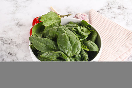 Green spinach leaves heap in the bowlの写真素材