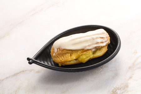 Delicious tasty eclair with ising and cream