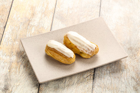 Delicious tasty eclair with ising and cream