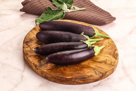 Small few baby eggplant over board for cookingの写真素材