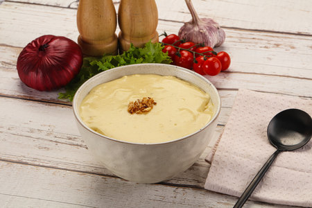 Gourmet cheese soup in the bowl with spicesの写真素材