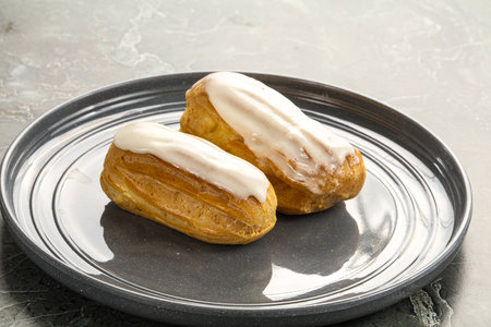 Delicious tasty eclair with ising and cream