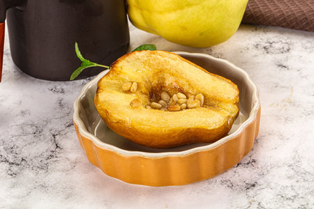 Baked quince with honey and cedar nutsの写真素材