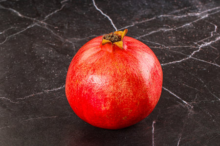 Ripe sweet juicy red pomegranate fruitの写真素材