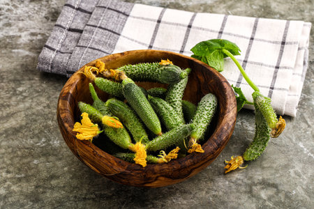 Raw gherkin cucumbers in the bowl served leafの写真素材