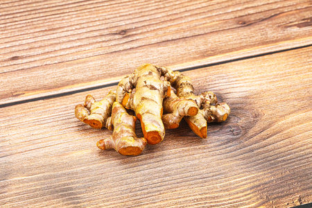 Fresh young Tumeric root heap for cooking