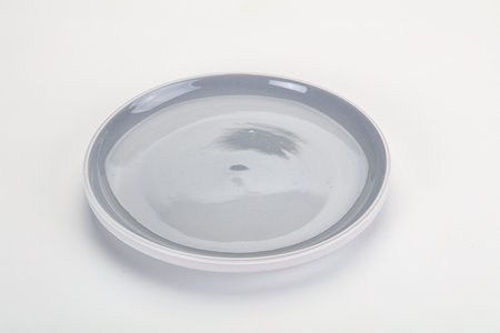 Empty clean color plate dishware isolatedの写真素材