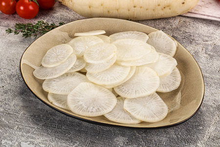 Sliced white raw daikon radish in the bowlの写真素材