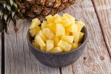 Sweet canned pineapple fruit pieces with syrupの写真素材