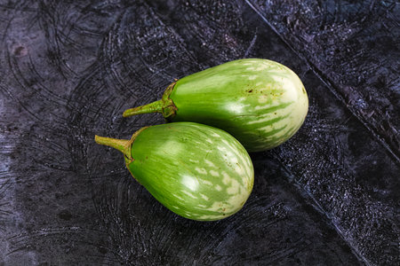 Ripe green mini eggplants heap for cookingの写真素材