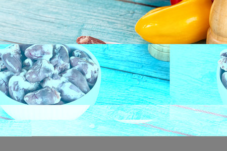 Raw chicken hearts for cooking in the bowlの写真素材