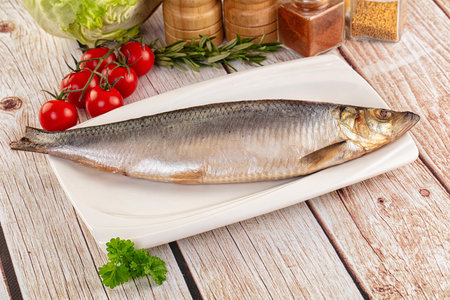 Raw whole salted herring fish served parsleyの写真素材