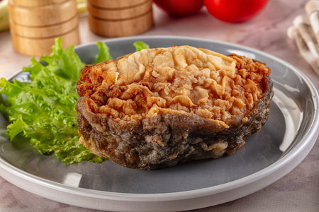 Roasted cod fish fillet piece in the plate