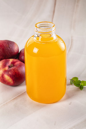 Vitamin beverage - peach juice glass served fruitsの写真素材