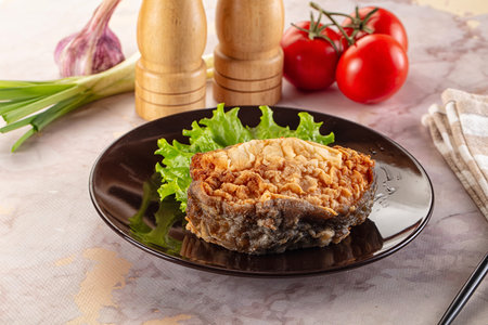 Roasted cod fish fillet piece in the plate