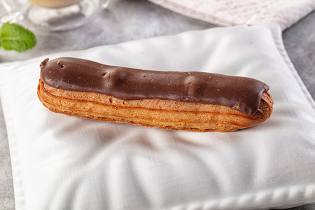 Gourmet chocolate eclair with brown icing