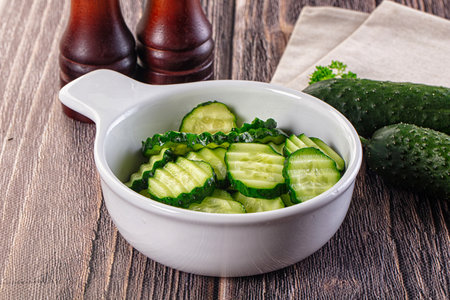 Fresh green ripe cucumber slices in the bowlの写真素材