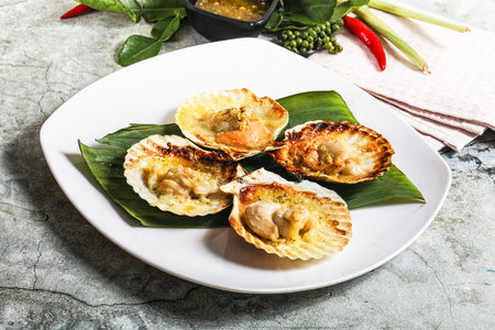 Griiled scallops in shell with cheese served sauceの写真素材