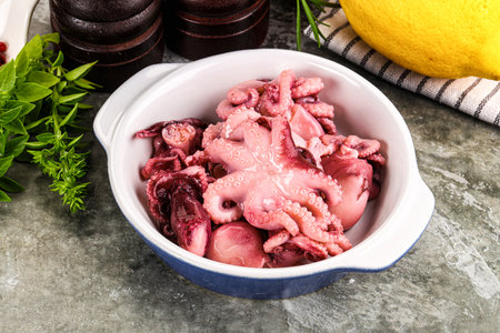 Marinated baby octopus snack appetizer served lemon