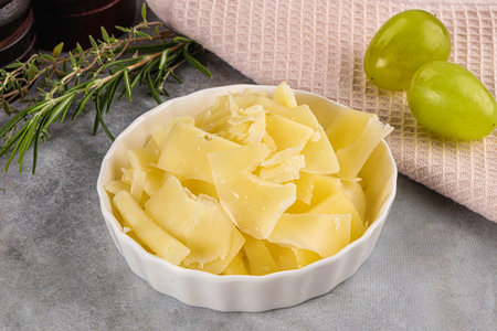 Aged Parmesan cheese slices in the bowl