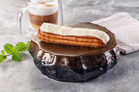 White delicous vanilla eclair with icing dessert