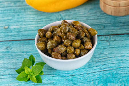 Pickled canned capers snack antipasti in the bowlの写真素材