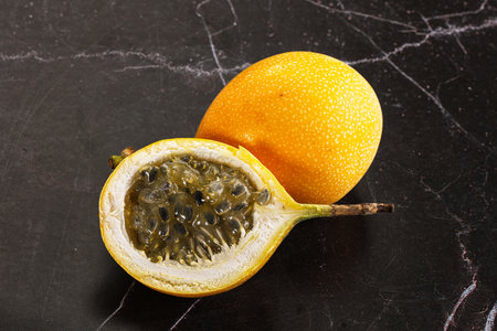 Yellow granadilla fruit with cut halfの写真素材