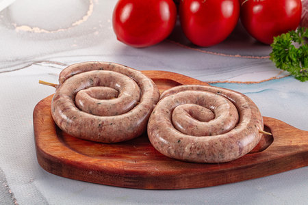 Raw meat pork and beef swirl sausages for grillの写真素材