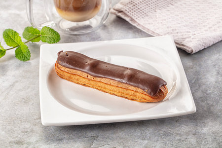 Gourmet chocolate eclair with brown icing